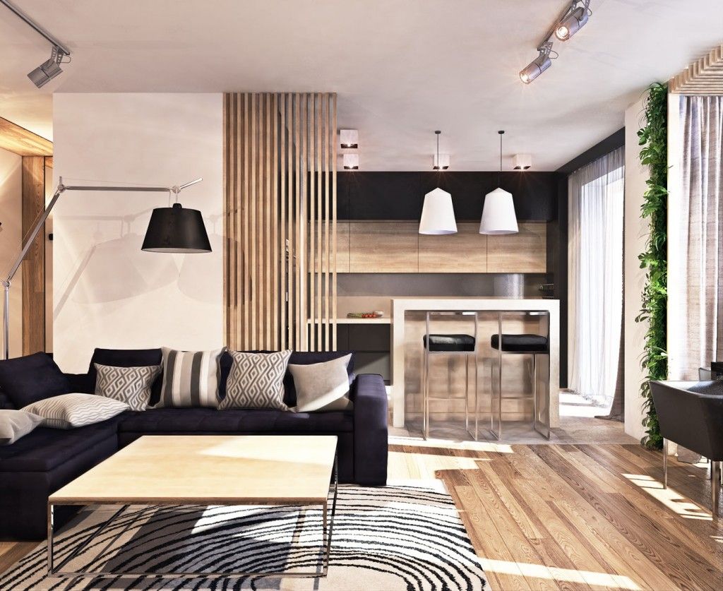 Ruang tamu modern dengan sofa gelap, aksen kayu, karpet bermotif, dan pencahayaan hangat alami